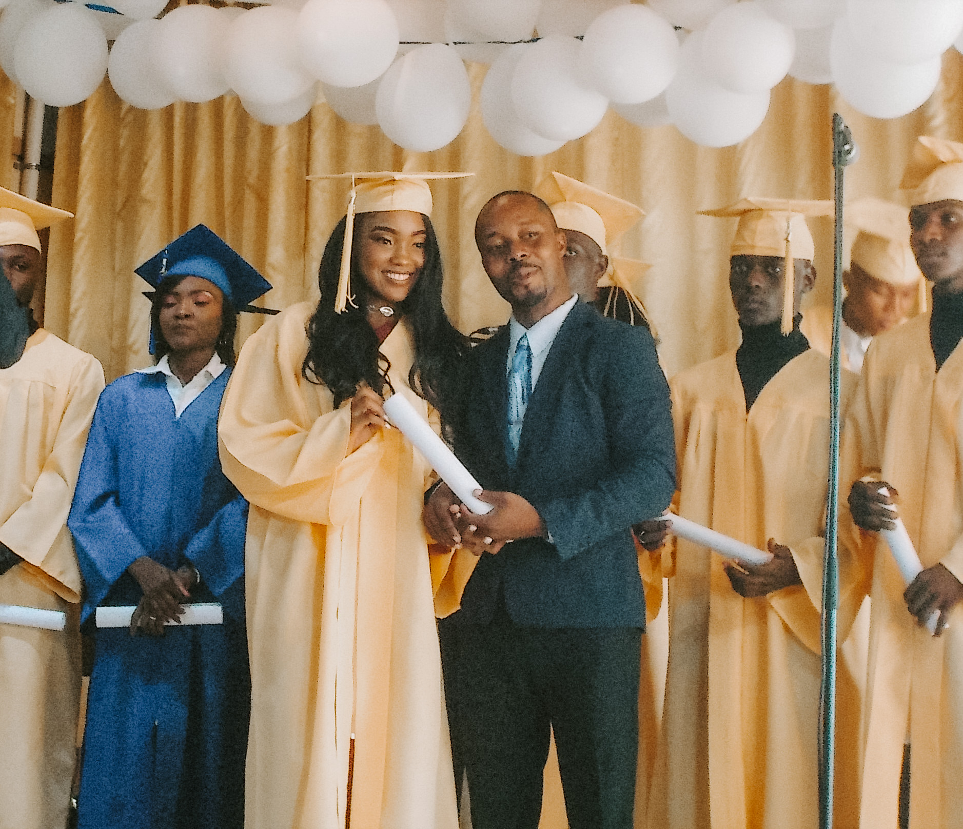 Photo of a girl receiving her diploma at a graduation