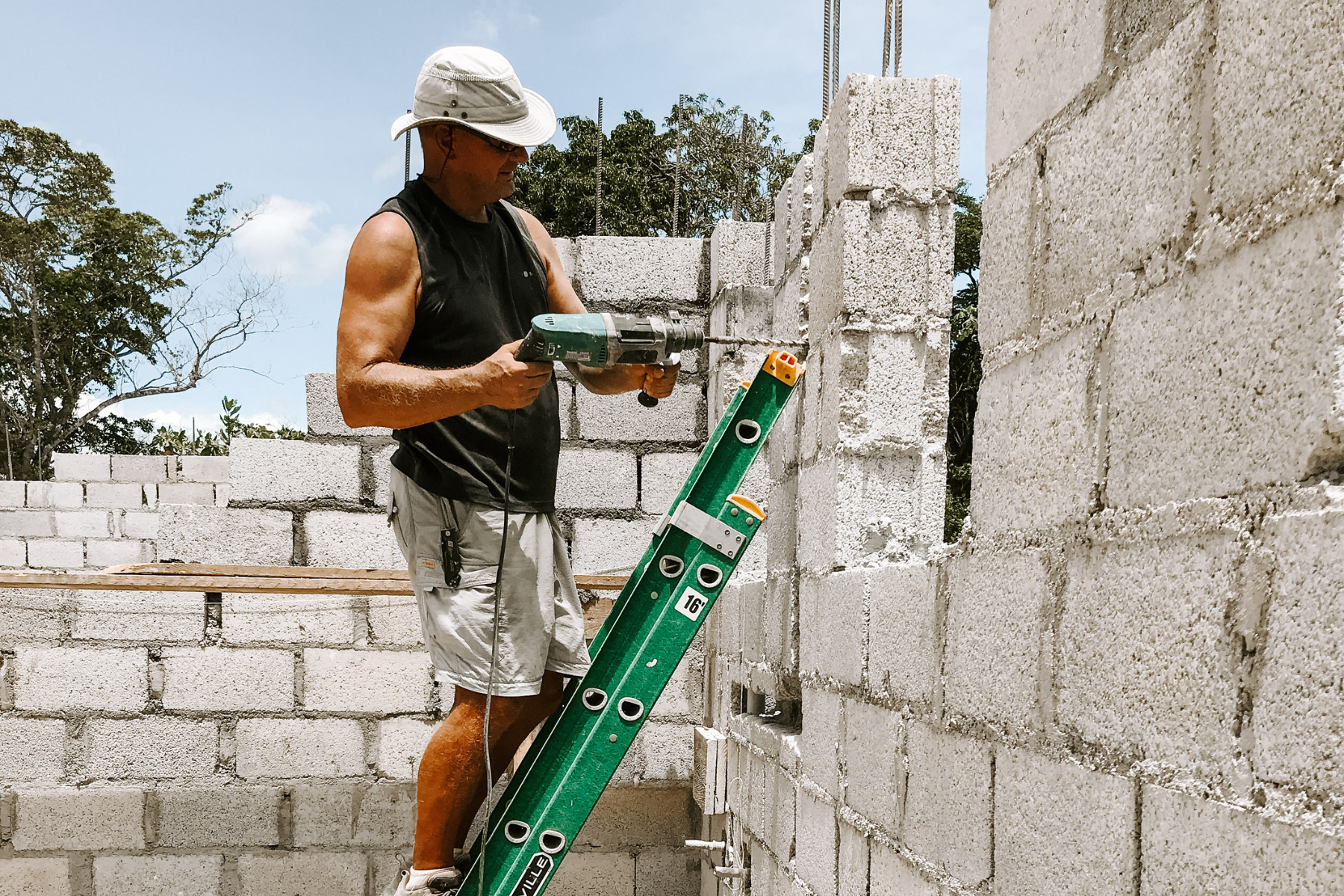 Photo of a man working on the foundation of a building