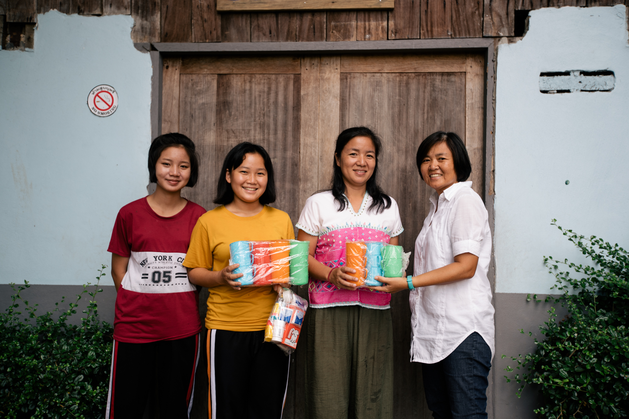 Photo of four ladies smiling while holding colourful cups from Imagine Thailand
