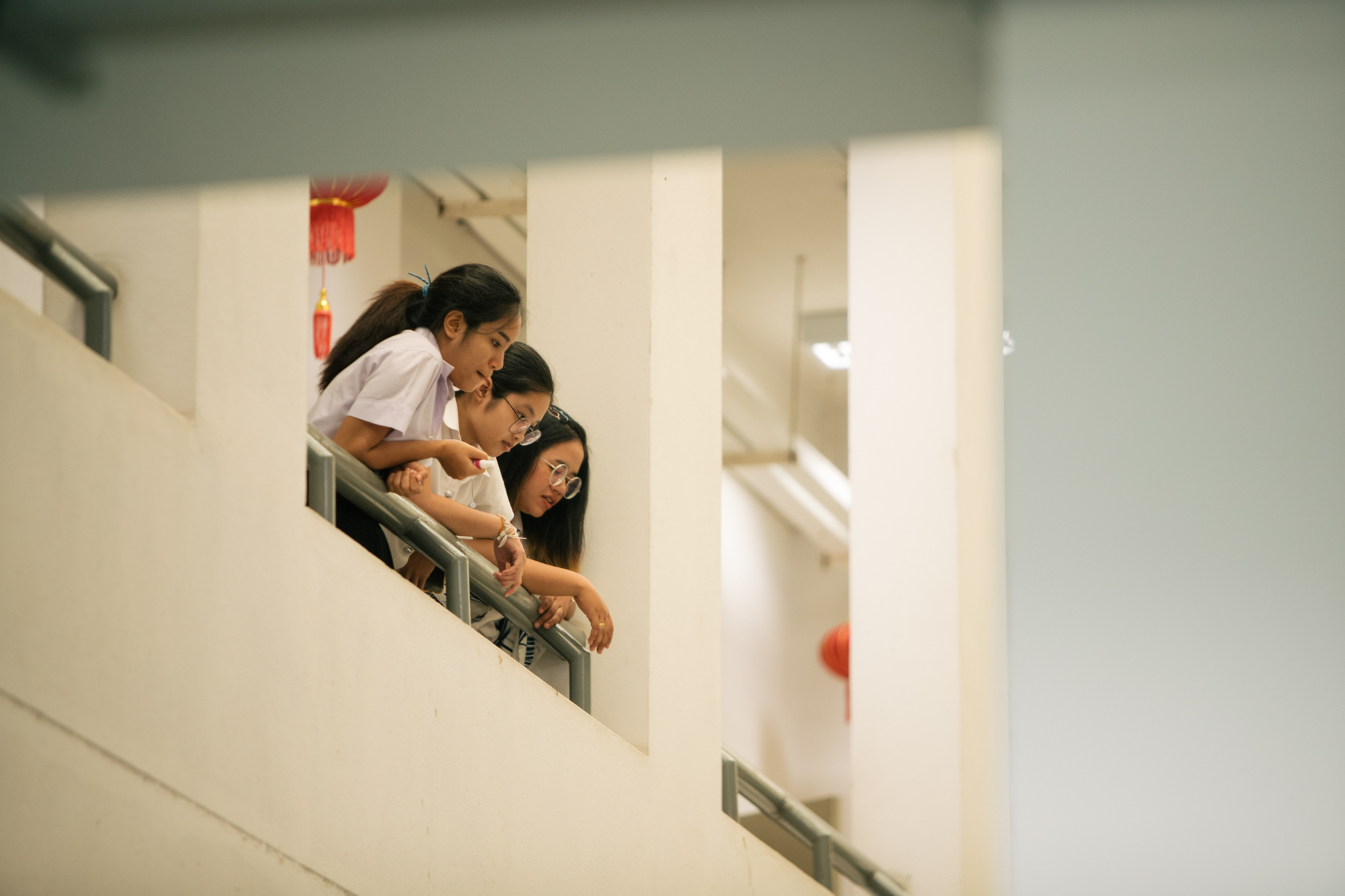 Photo of three girls against a railing at Imagine Thailand