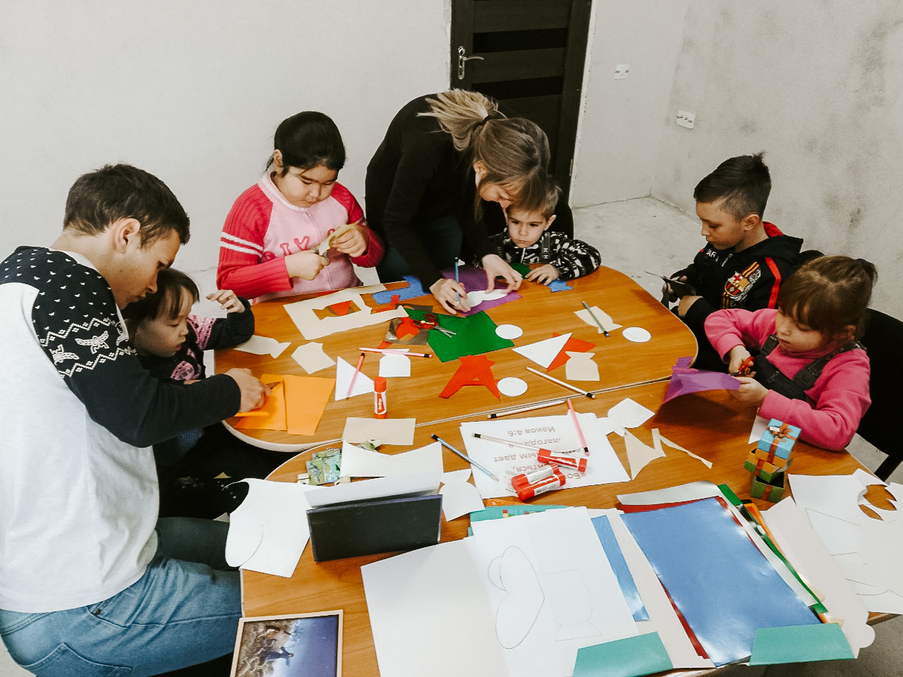 Photo of kids around a table working on a project,