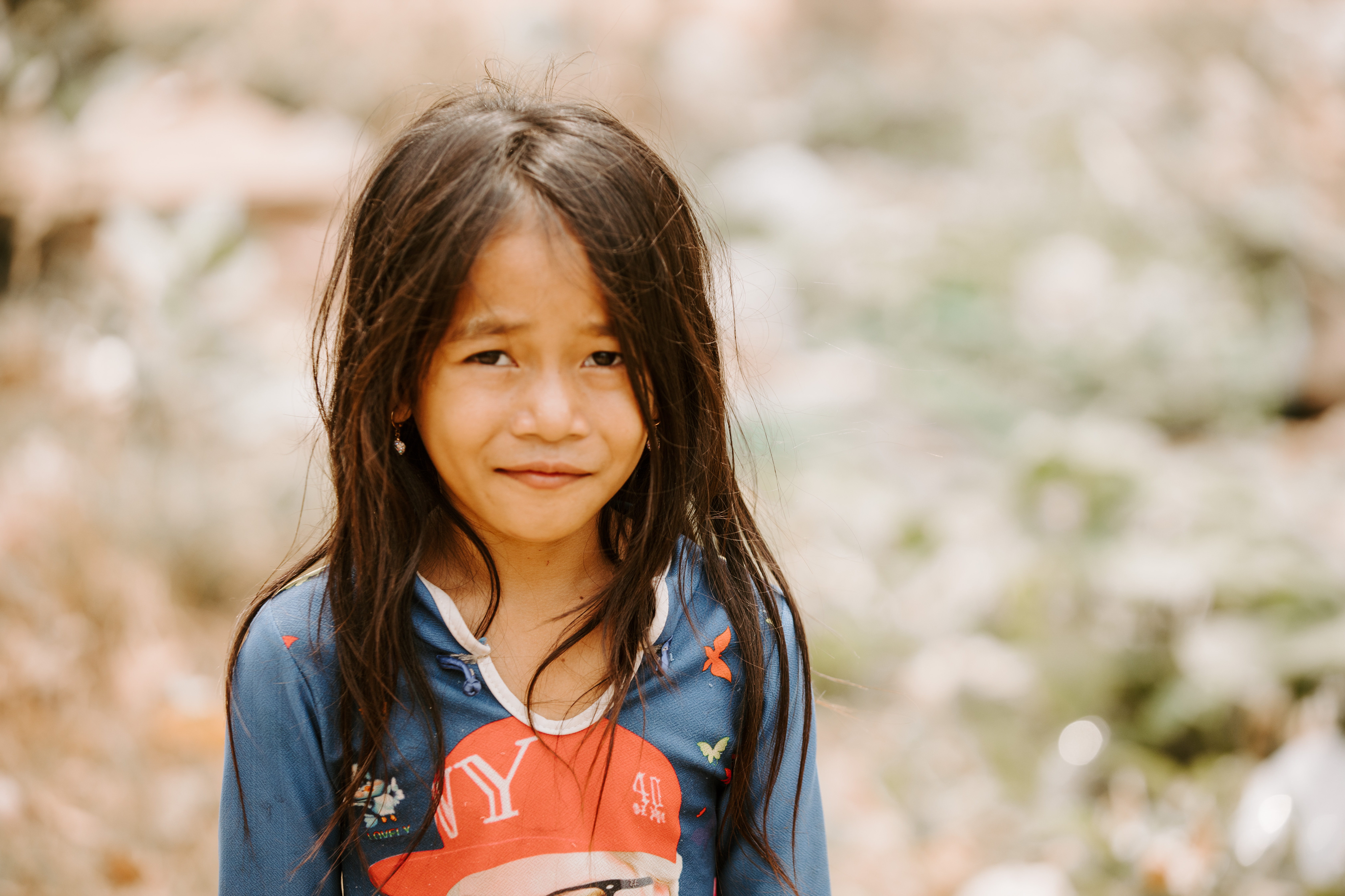 Photo of a little girl smiling at the camera from Cambodia