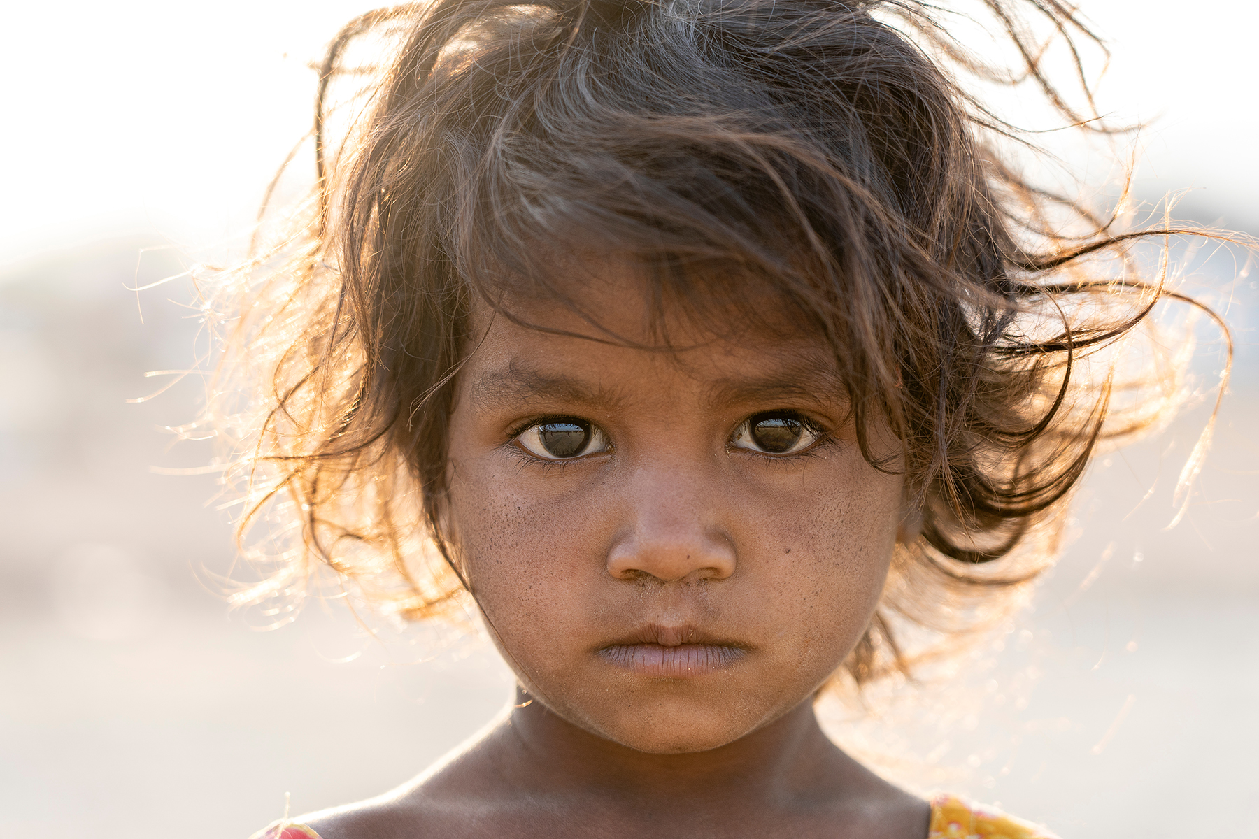 Photo of a little girl looking at the camera from Shutterstock.