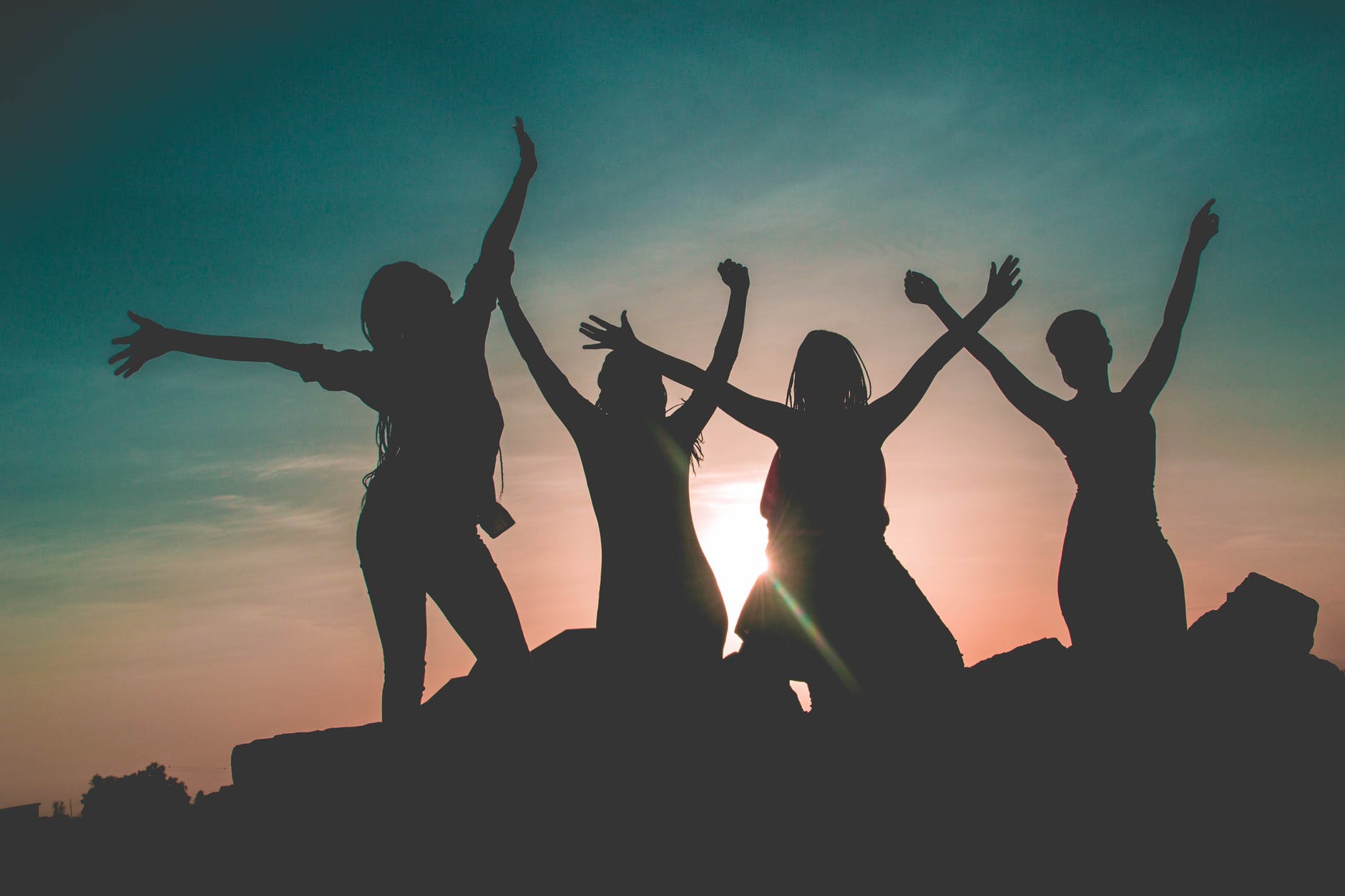 Silhouette of a group of girls with their hands out