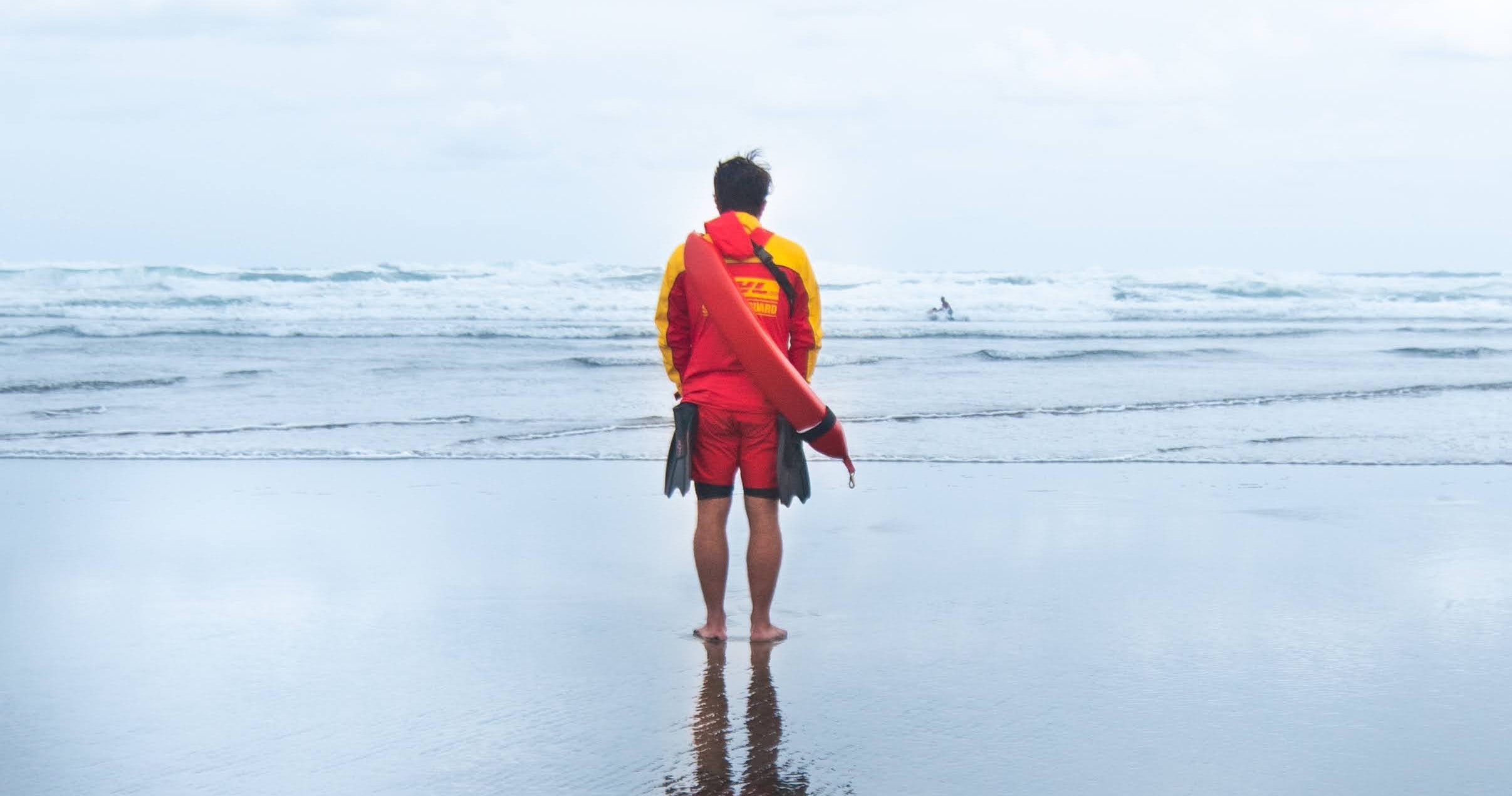 Photo by Ian Kuik on Unsplash of a lifeguard on the beach.