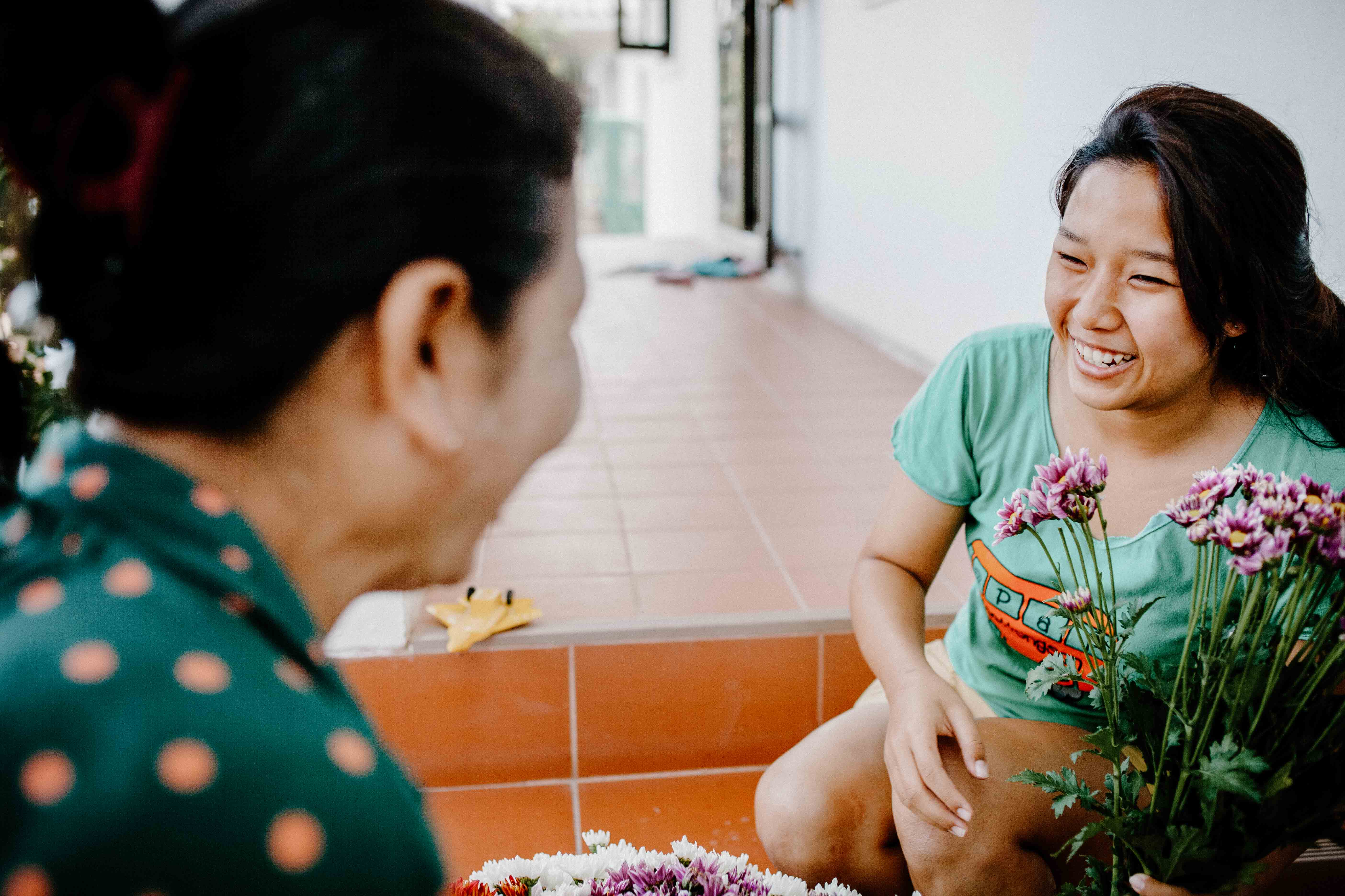 Photo of two ladies smiling at each other from Thailand.