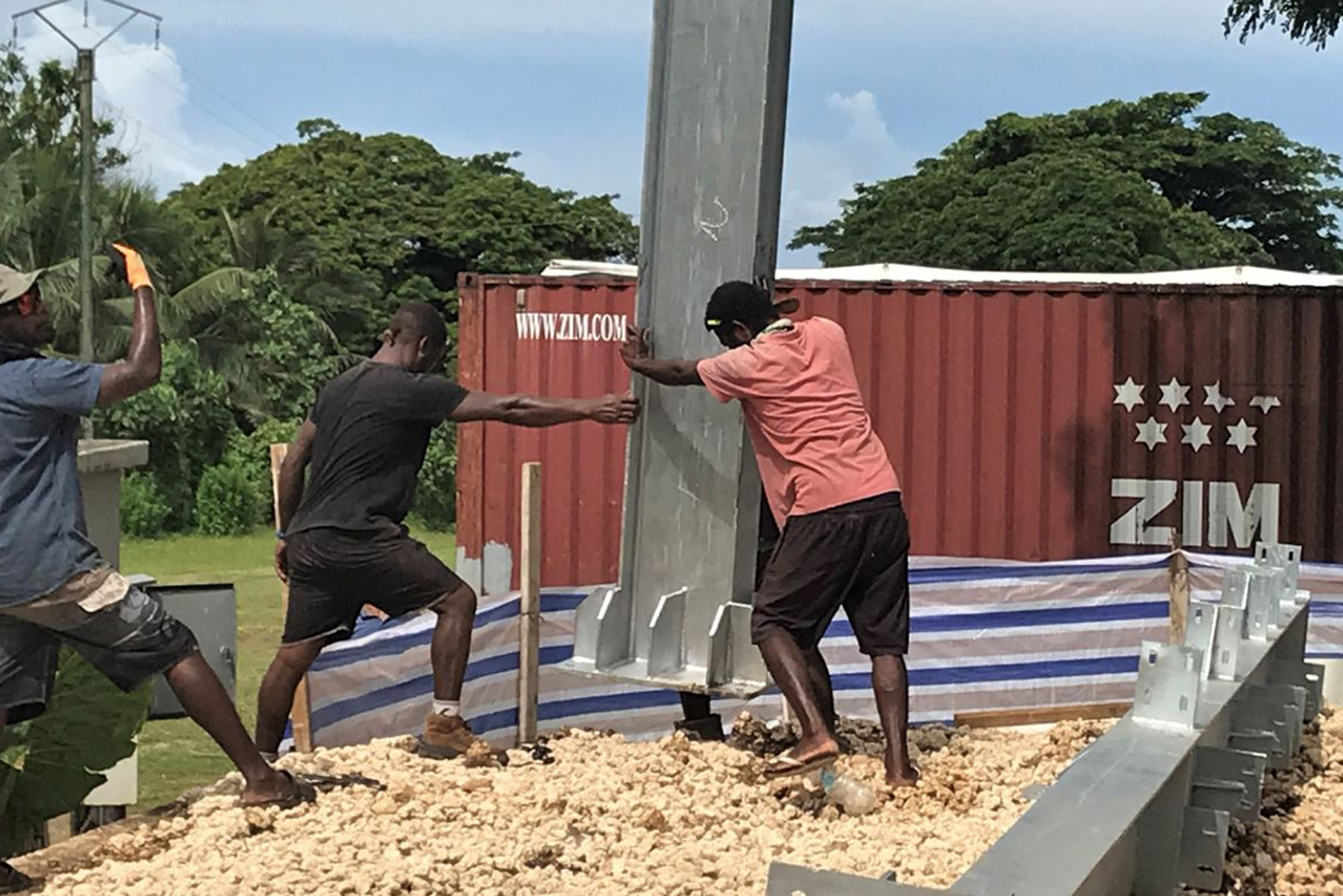 Photo of two men working on the foundation of the Vanuatu Church Project.