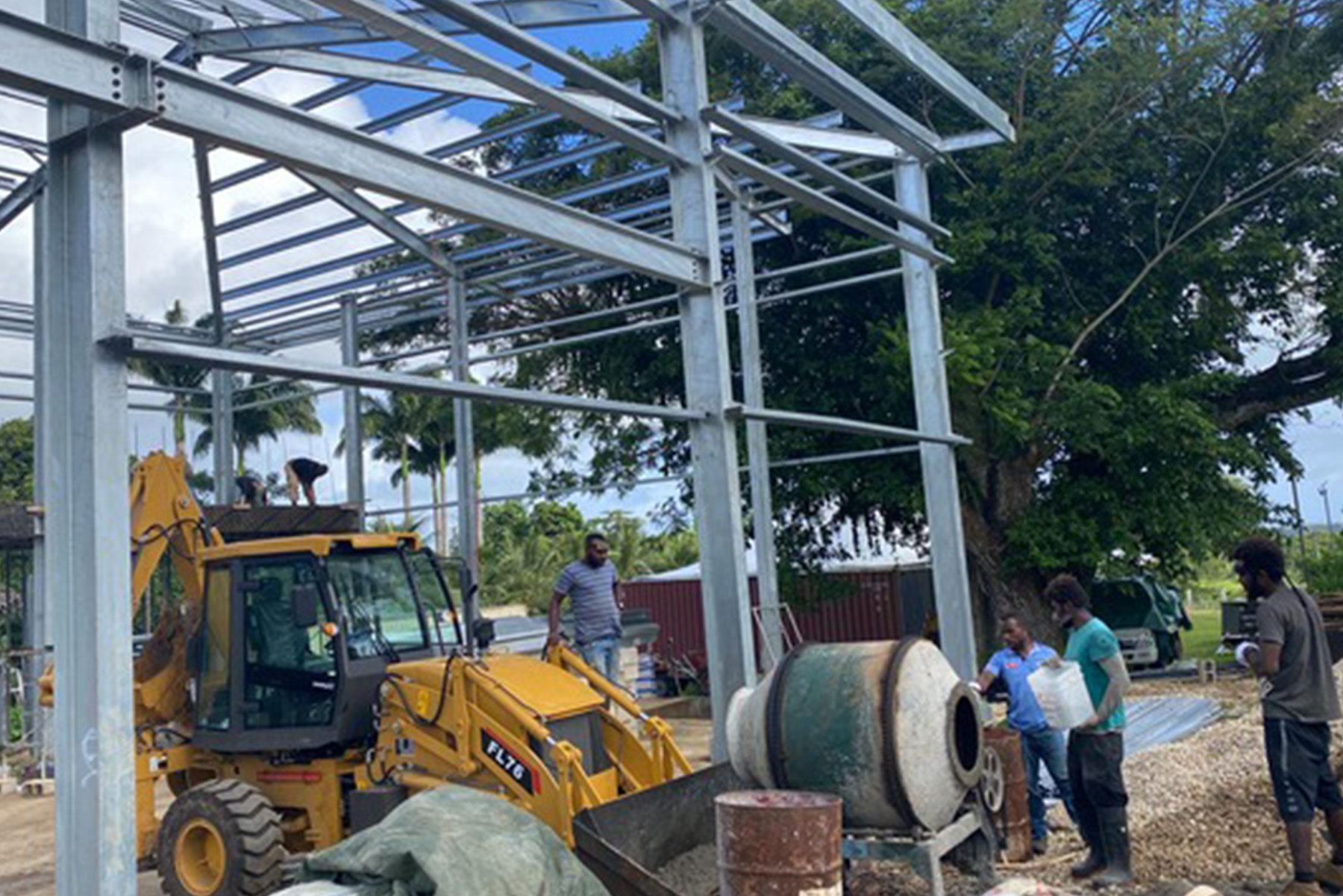 Photo of a group of men working on the foundation of the Vanuatu Church Project.