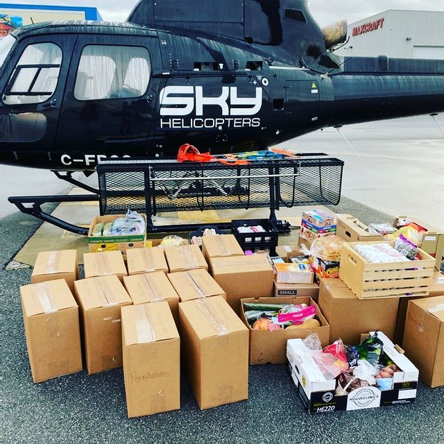 A helicopter with boxes to help victims of the flooding in B.C.