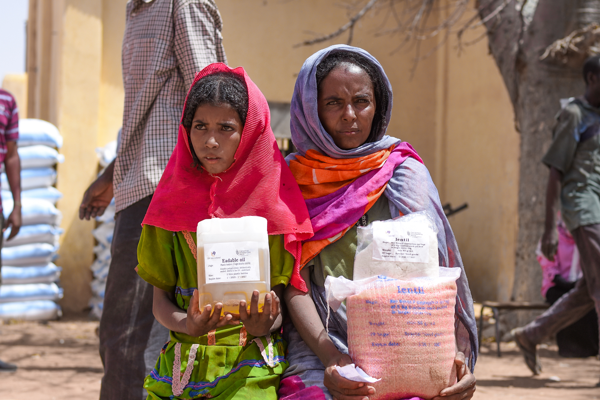 Beneficiaries received food basket 4 Two woman carrying food baskets.