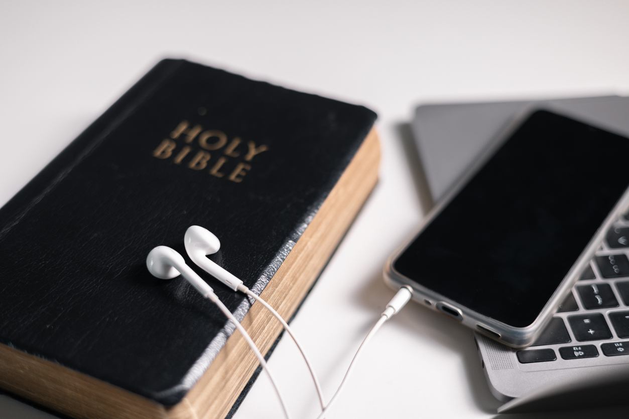 A Bible next to a phone.