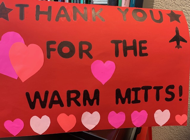 Sign reading "Thank you for the warm mitts!"