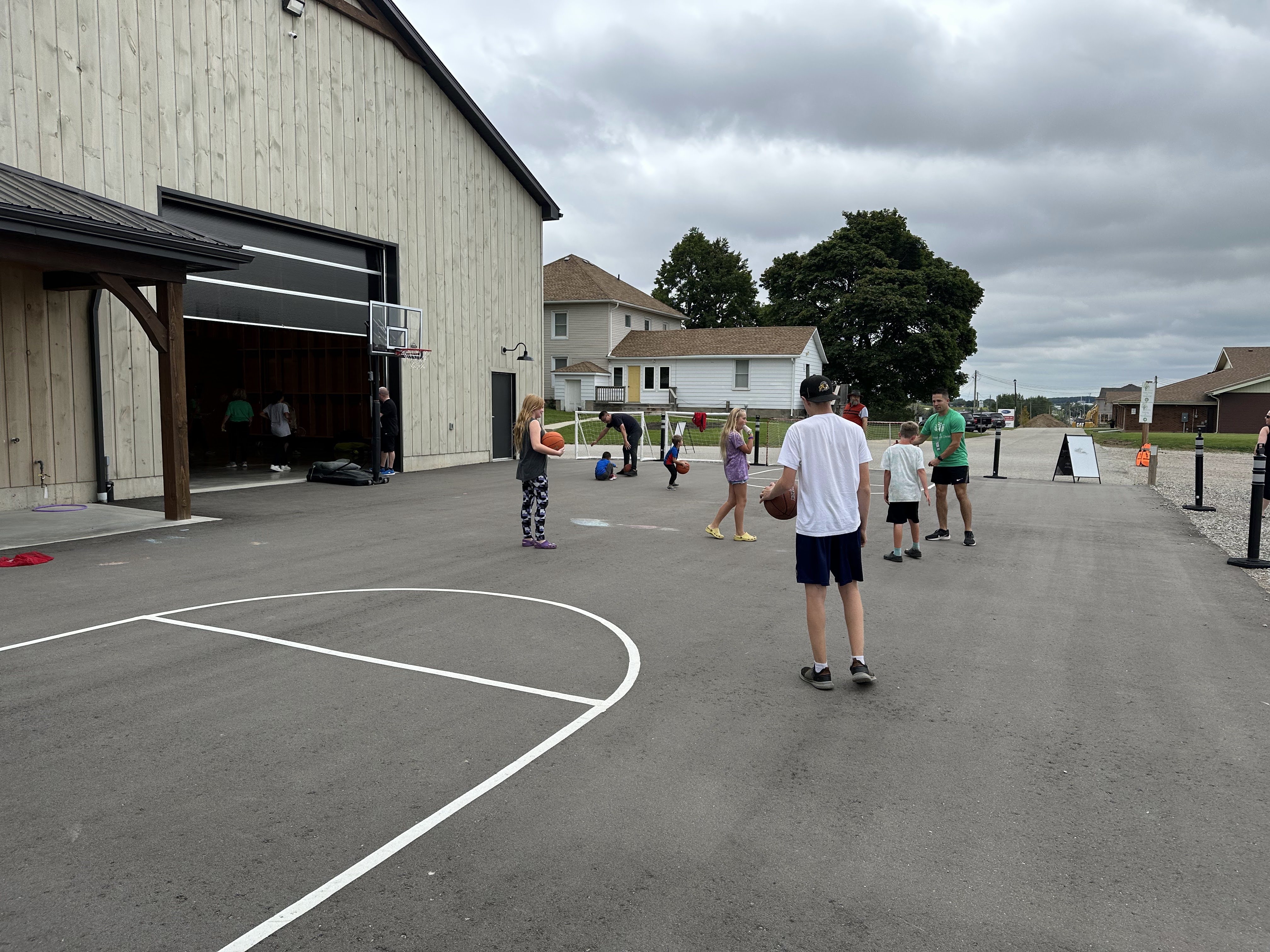 Youth playing on a basketball court.