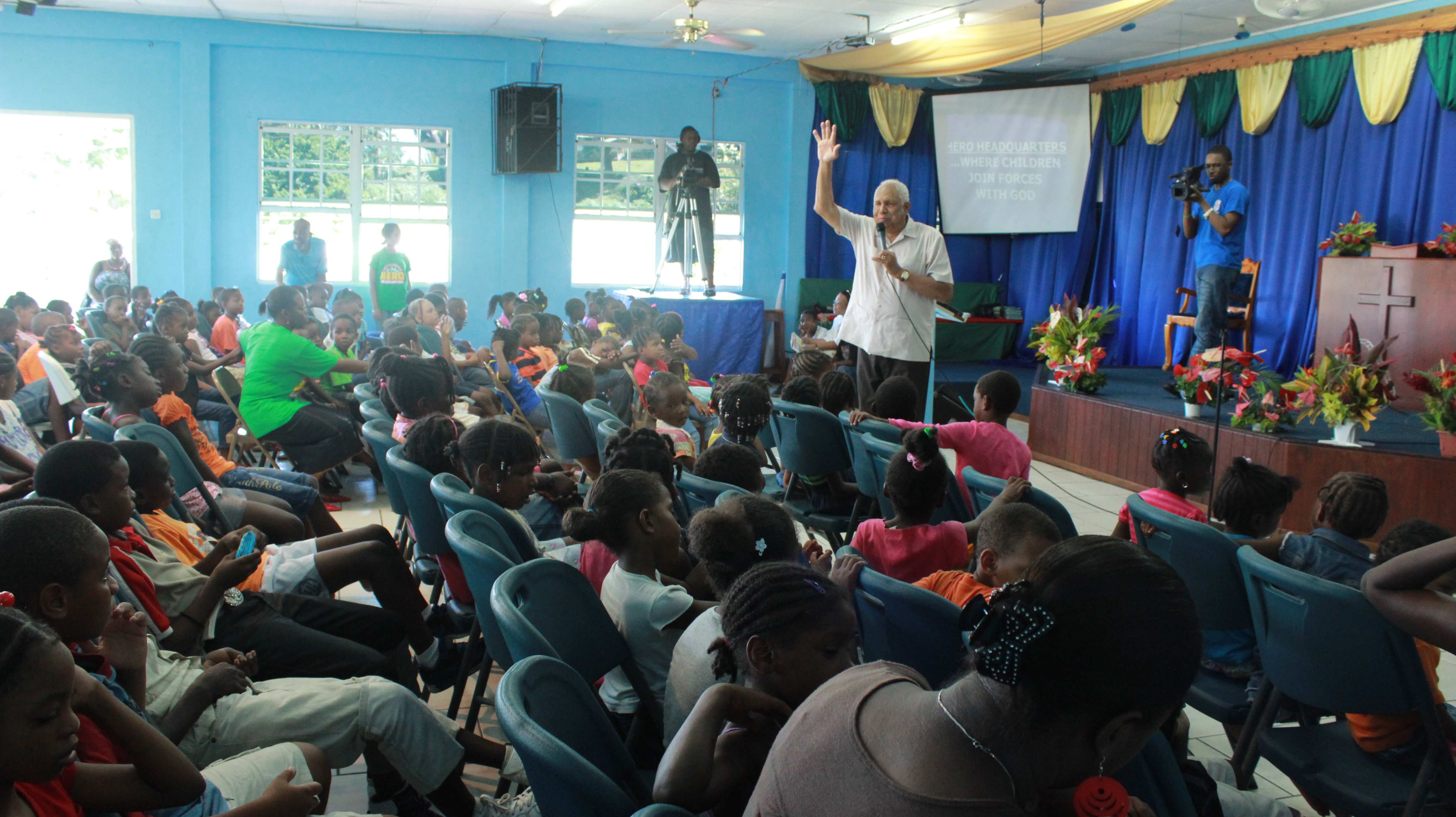 Pastor Dennis speaks to a Vacation Bible School.